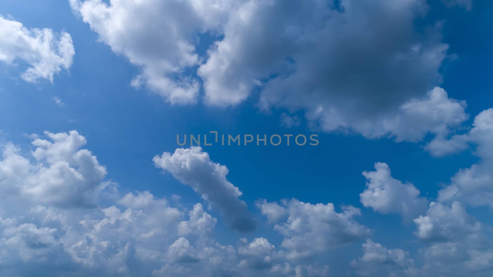 White and Dark Fluffy Clouds Floating in the Bright Blue Skies on a Summer Day