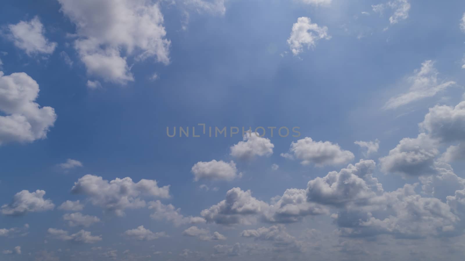 White and Dark Fluffy Clouds Floating in the Bright Blue Skies on a Summer Day