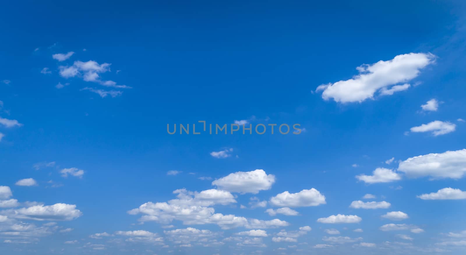White Fluffy Clouds Floating in the Bright Blue Skies on a Summer Day