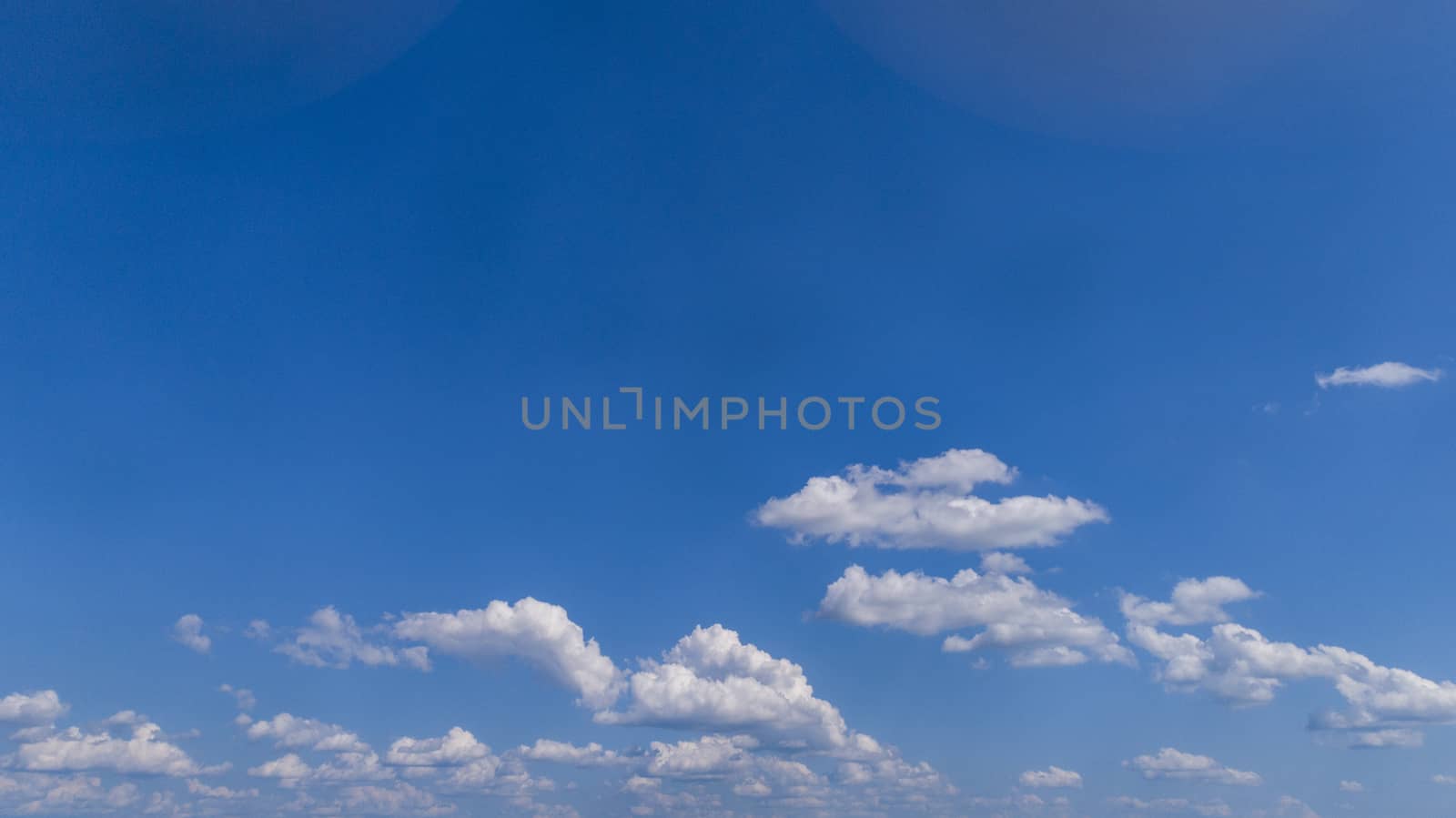 White Fluffy Clouds Floating in the Bright Blue Skies on a Summer Day