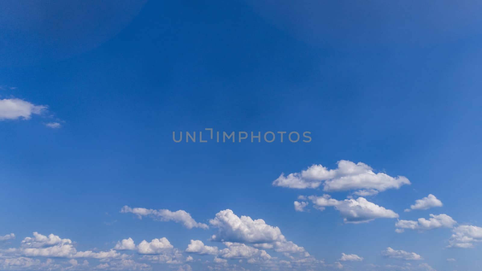 White Fluffy Clouds Floating in the Bright Blue Skies on a Summer Day