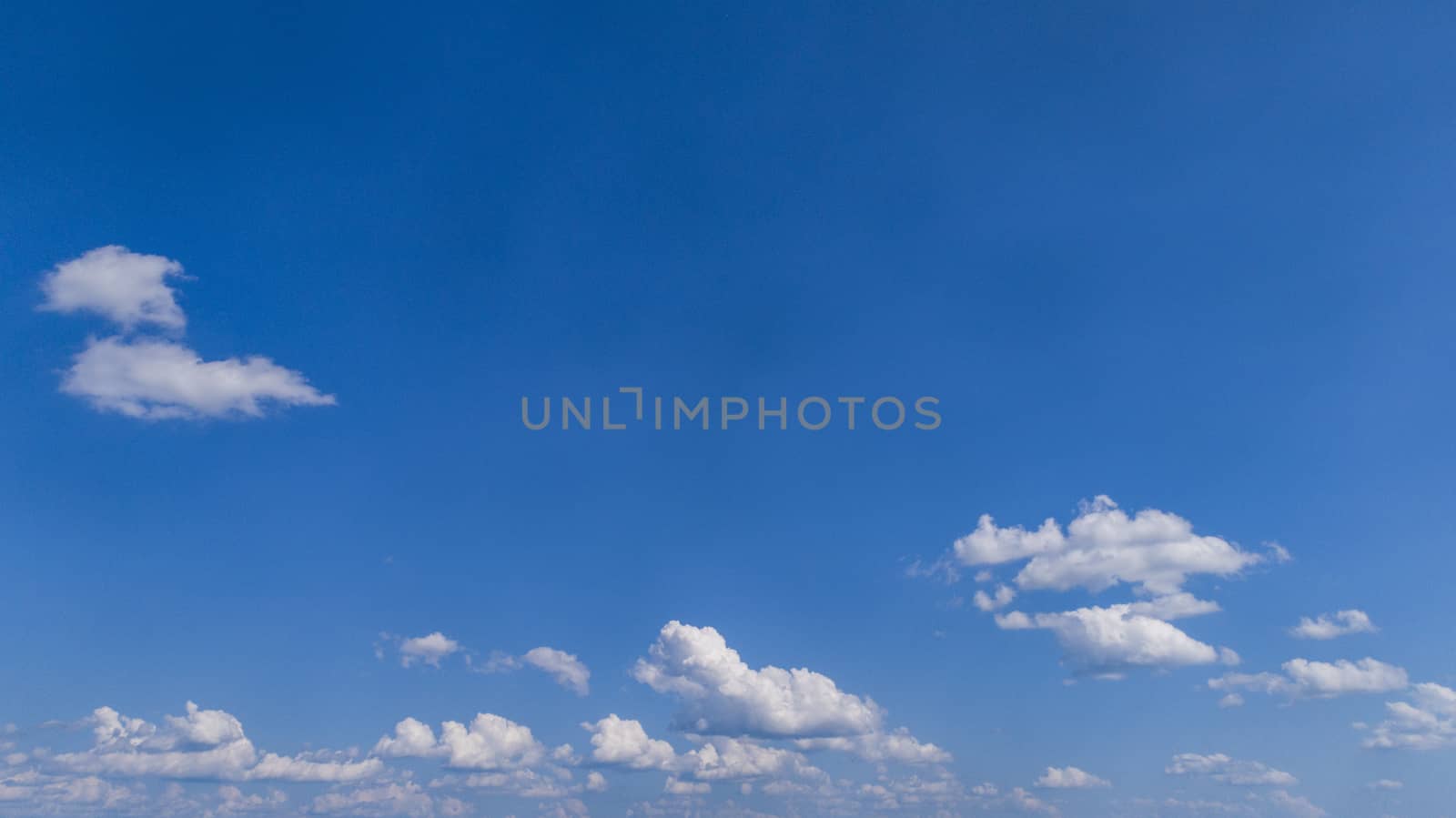White Fluffy Clouds Floating in the Bright Blue Skies on a Summer Day