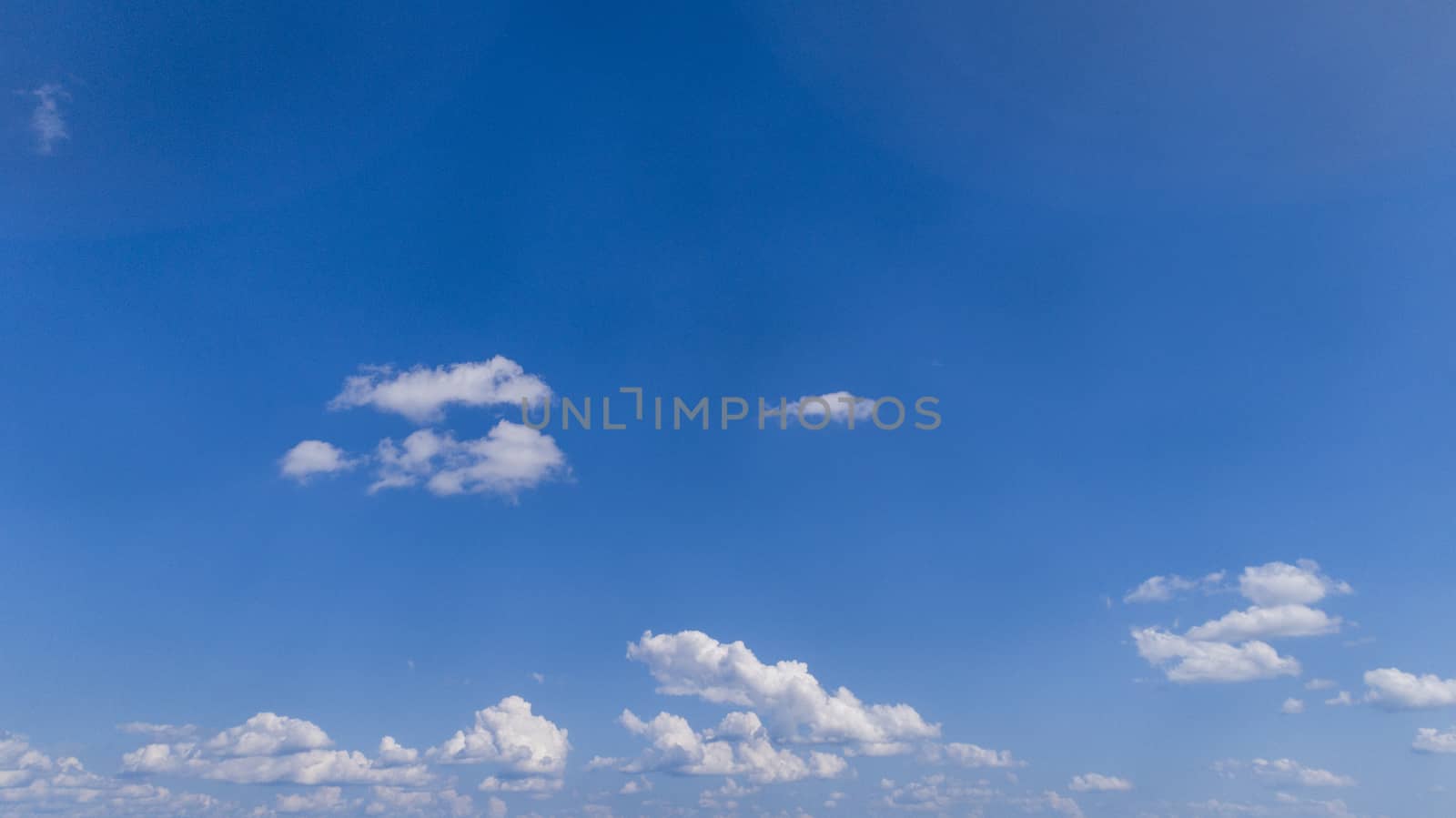 White Fluffy Clouds Floating in the Bright Blue Skies on a Summer Day