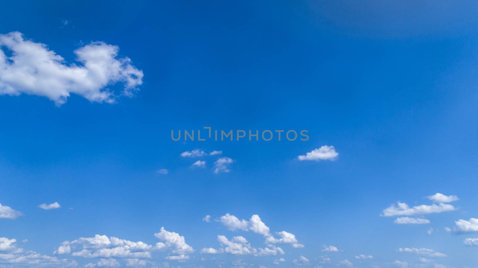 White Fluffy Clouds Floating in the Bright Blue Skies on a Summer Day