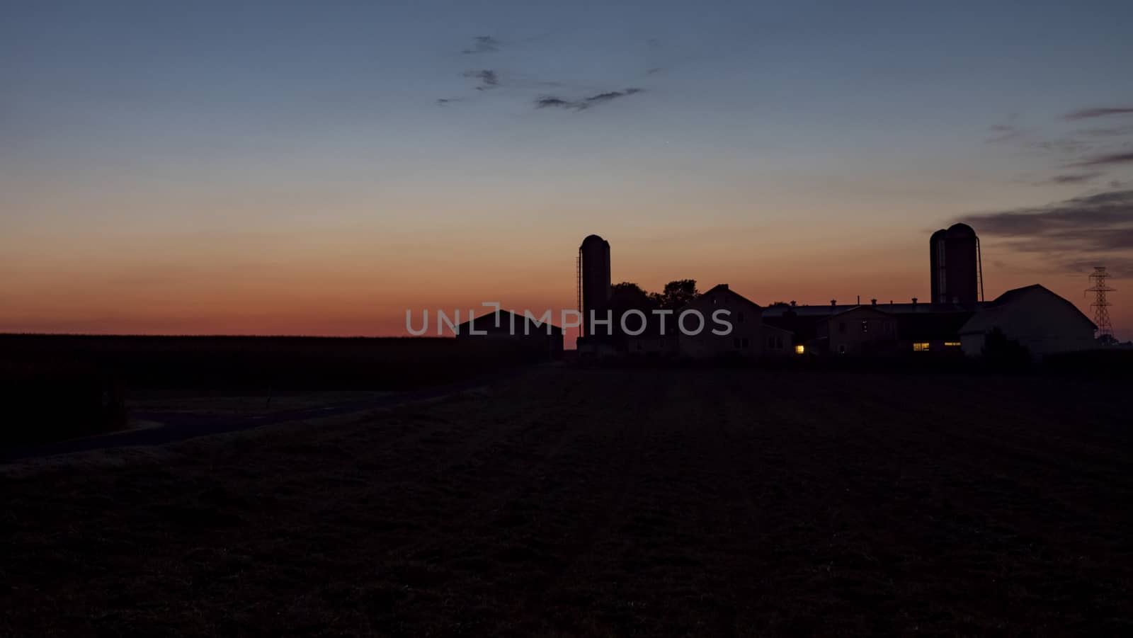 An Aerial View of a Sunrise Over an Amish Farm with Blues and Reds on a Clear Summer Morning