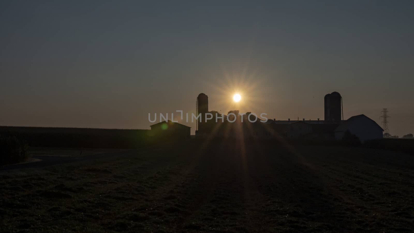 An Aerial View of a Sunrise Over an Amish Farm with Blues and Reds on a Clear Summer Morning