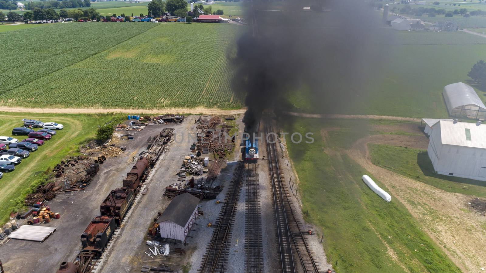 Aerial View of Train Yard Waiting for Thomas the Train Puffing Smoke on a Sunny Summer Day