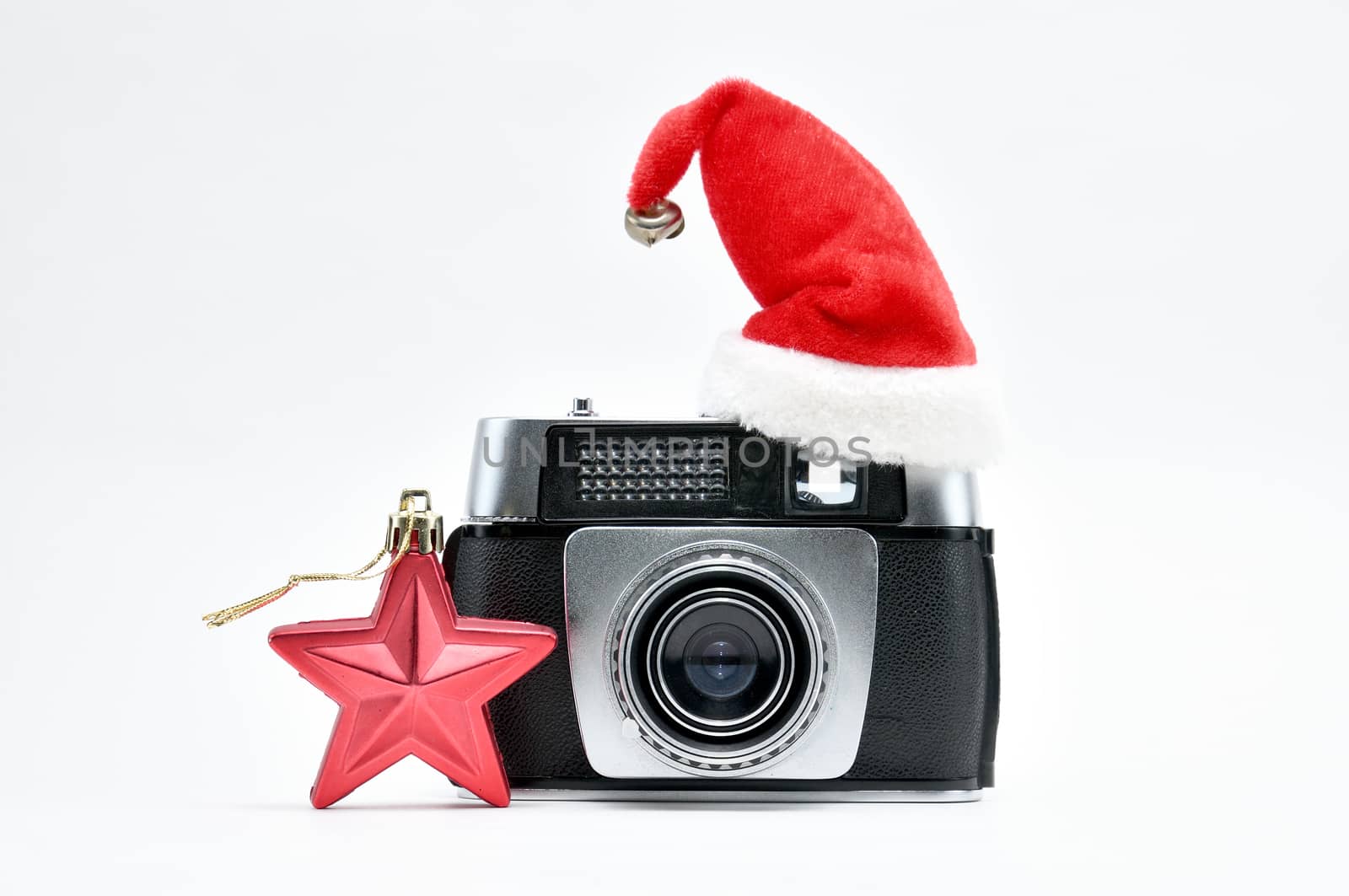 Vintage camera surrounded by Christmas toys, Santa's Christmas tree and caps.For Isolation.
