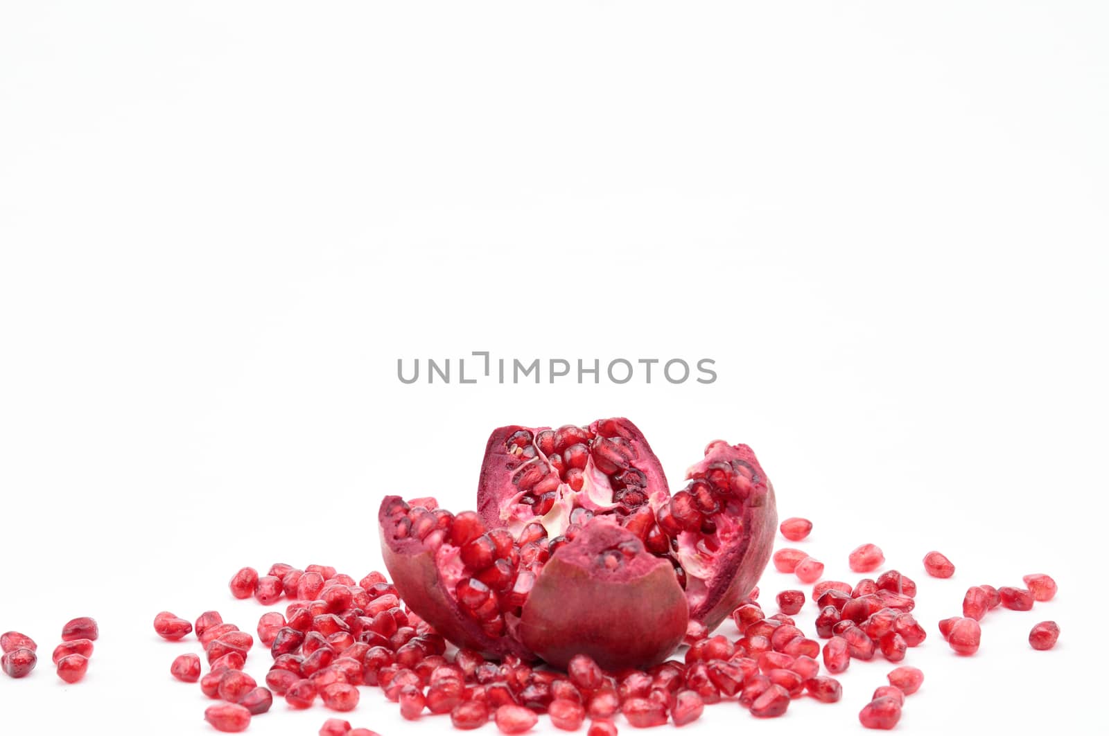 Pomegranate on a white background.Natural.For Isolation. by moviephoto