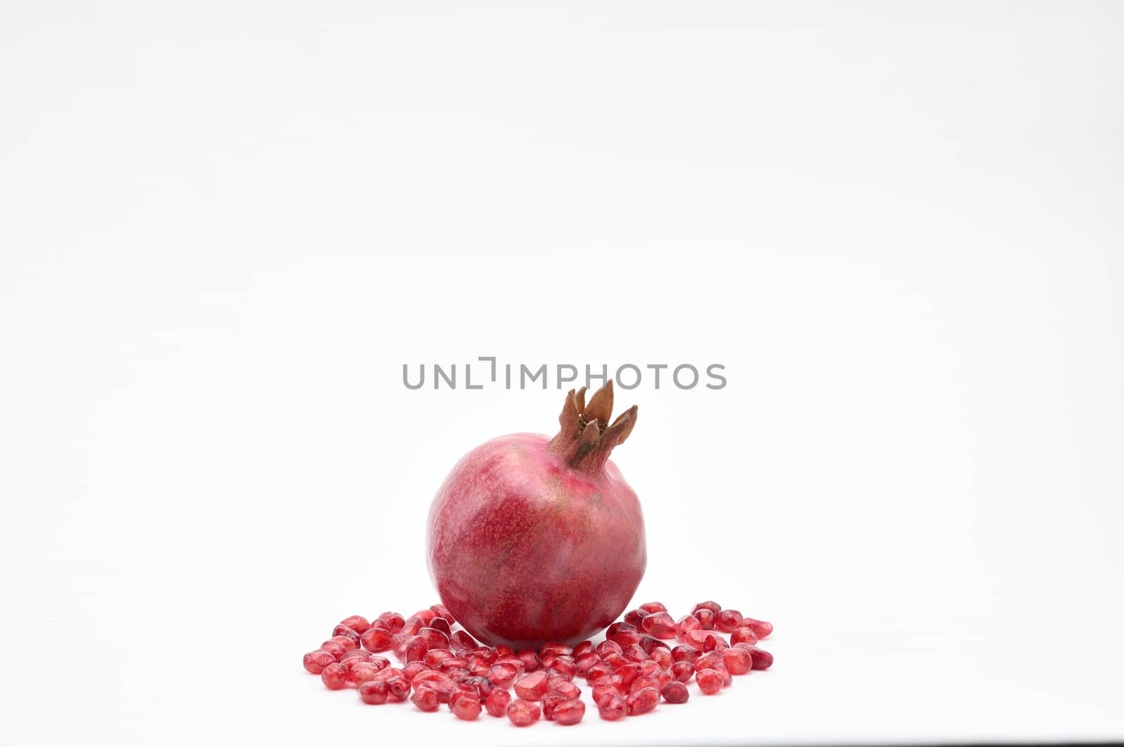 Pomegranate on a white background.Natural.For Isolation. by moviephoto