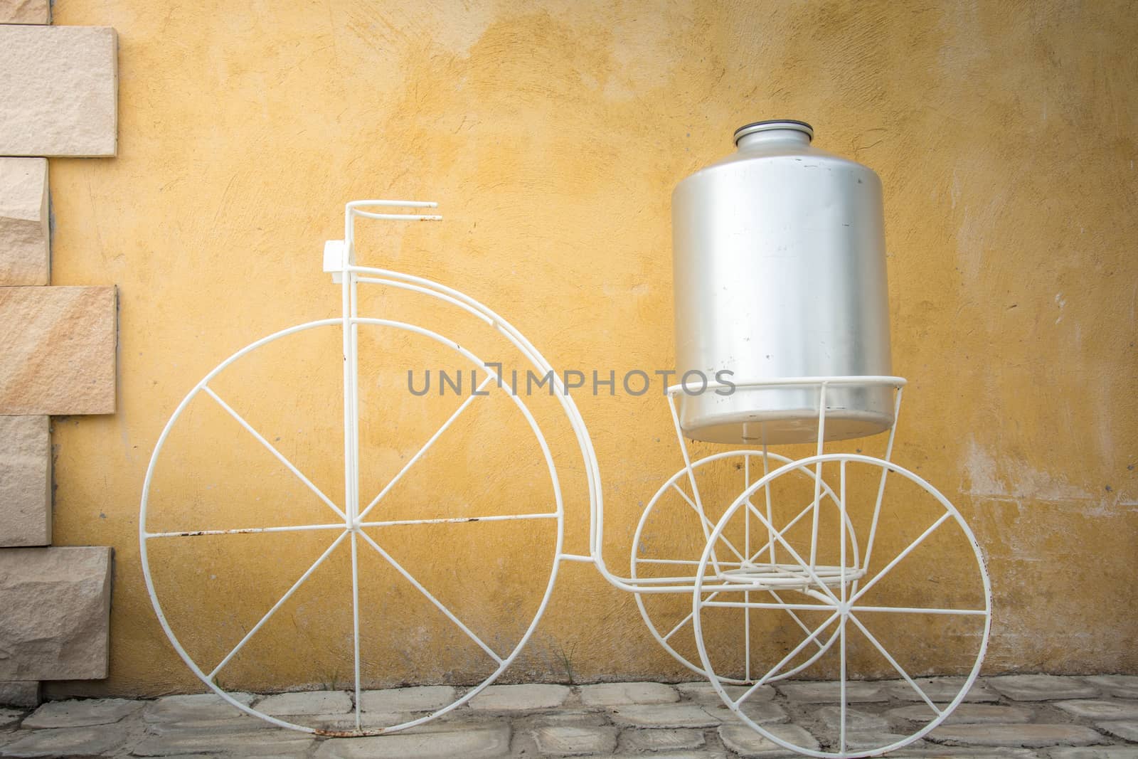 light on white decor bicycle on the rock wall background.