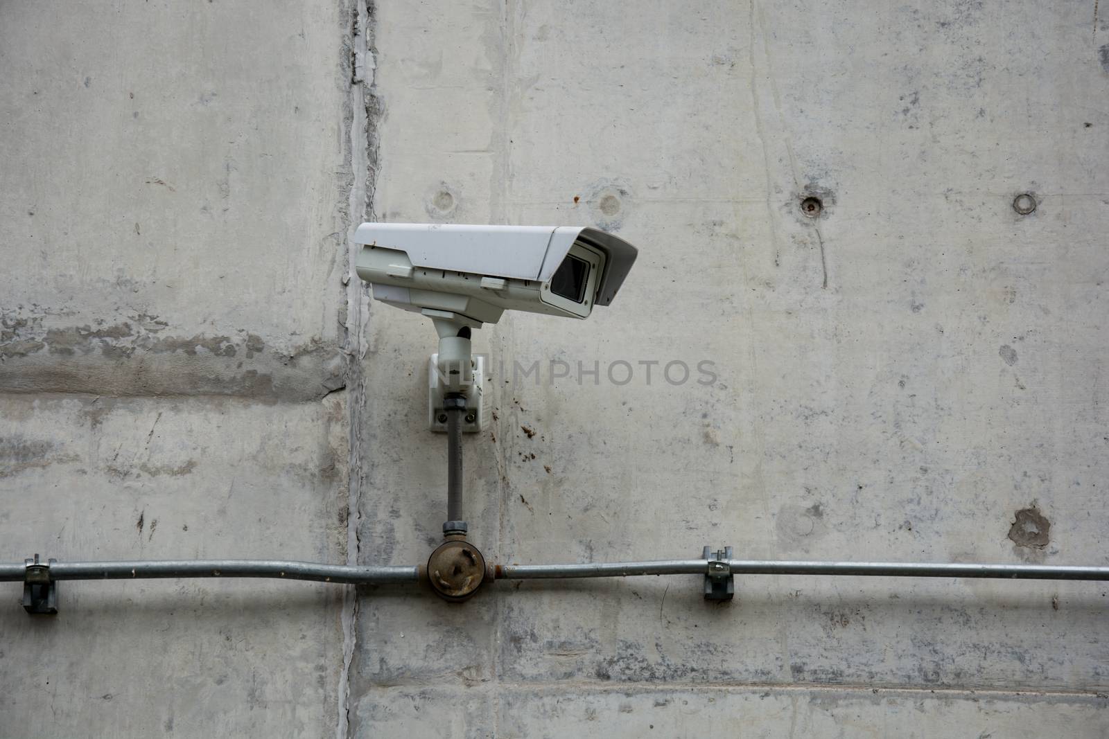 CCTV camera on the wall by shutterbird