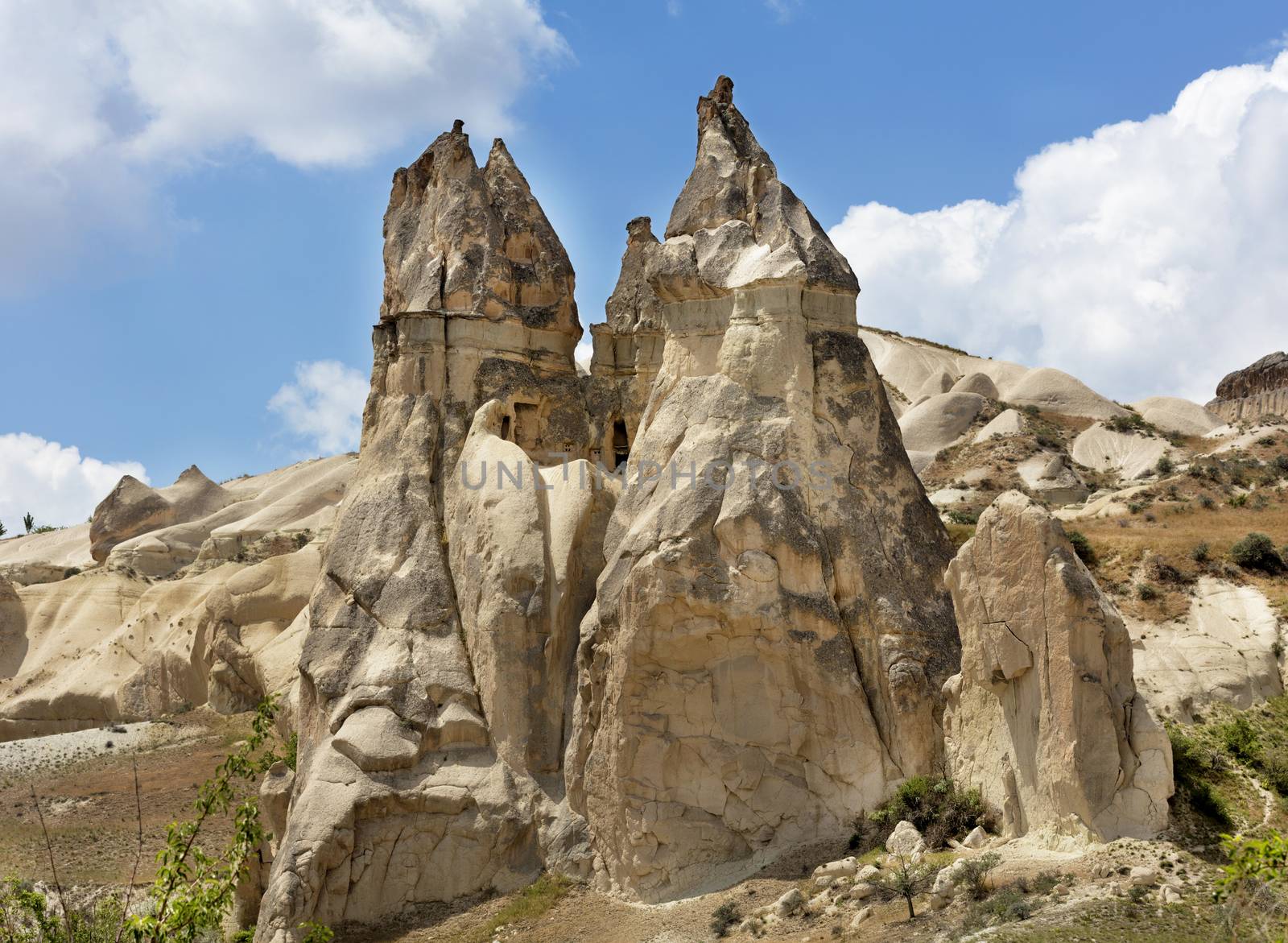 Stone conical houses in the ancient rocks of Goreme, Cappadocia. Rural landscape in the rural way of life of old mountain formations.