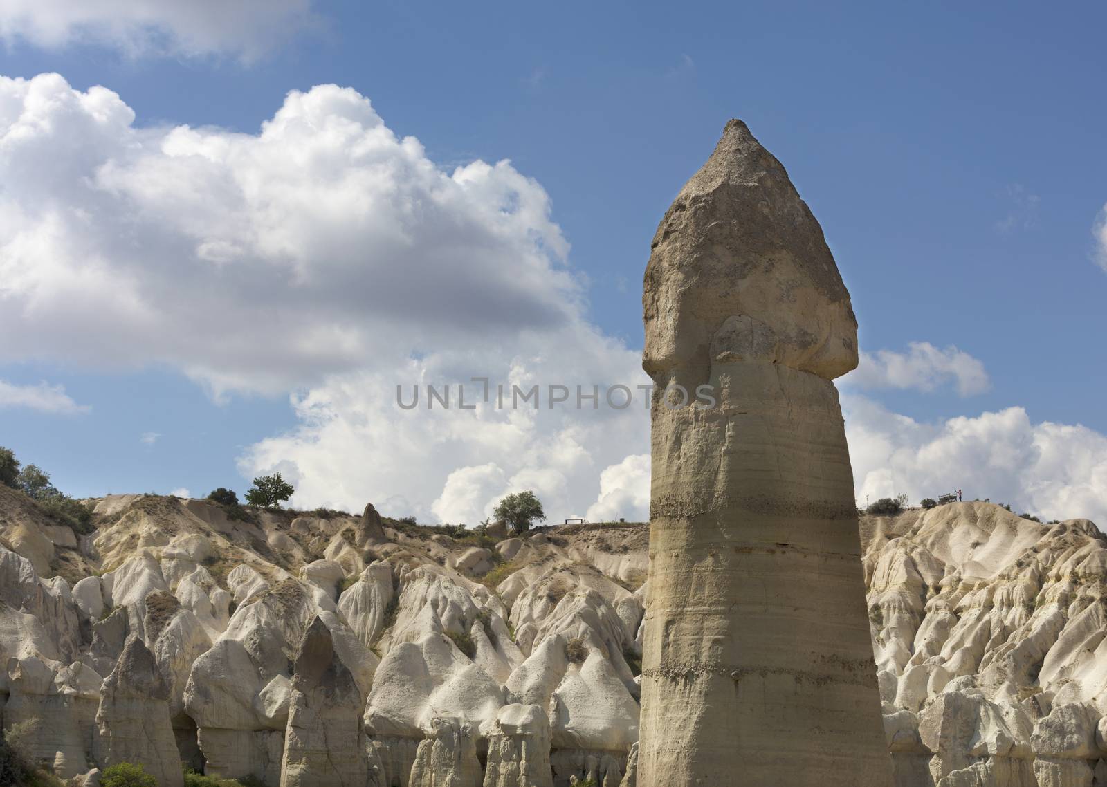 Rural landscape in the Valley of Love, Cappadocia. Large phallic rock formations against the blue summer sky.