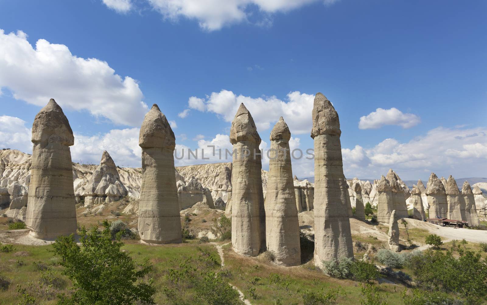 Rural landscape in the Valley of Love, Cappadocia. Large phallic rock formations against the blue summer sky.