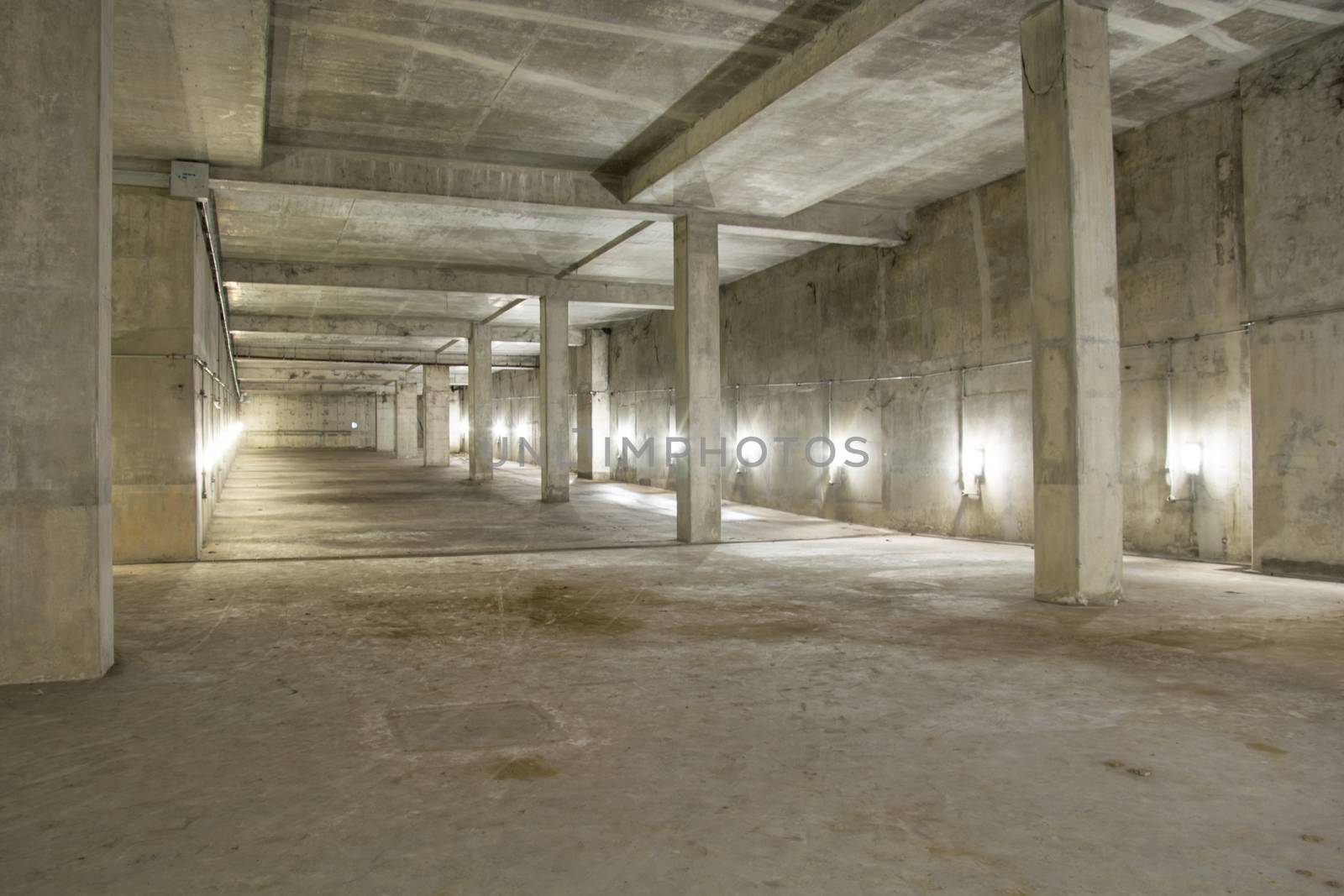 Empty industrial garage room interior with concrete floor and wall background