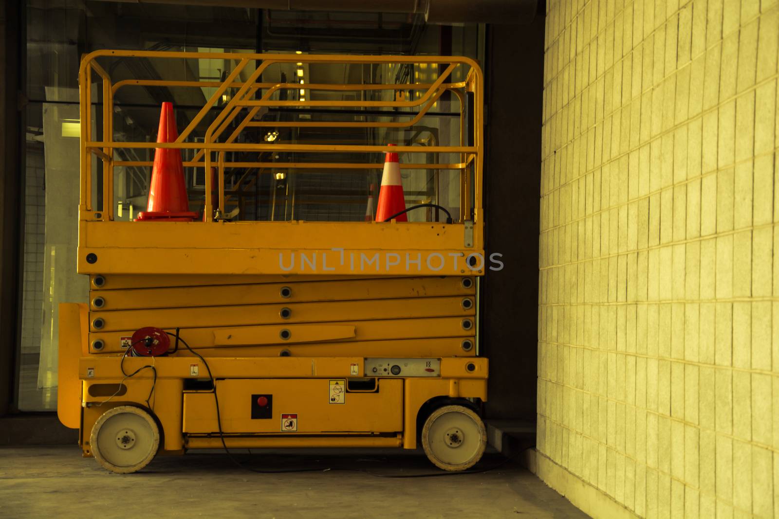 distribution warehouse hall with hydraulic scissors lift platform, vintage color style