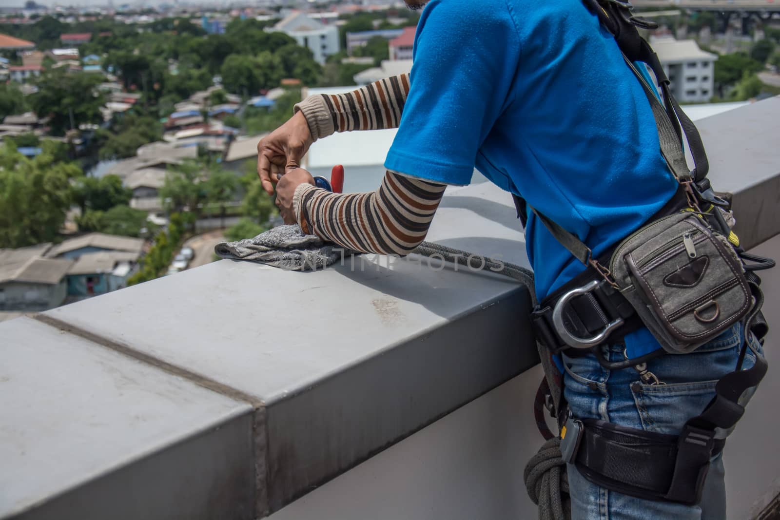 workers cleaning windows service on high rise building
