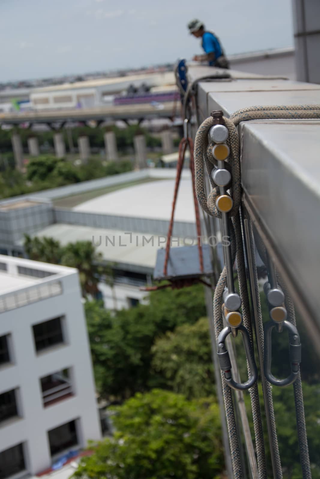workers cleaning windows service on high rise building