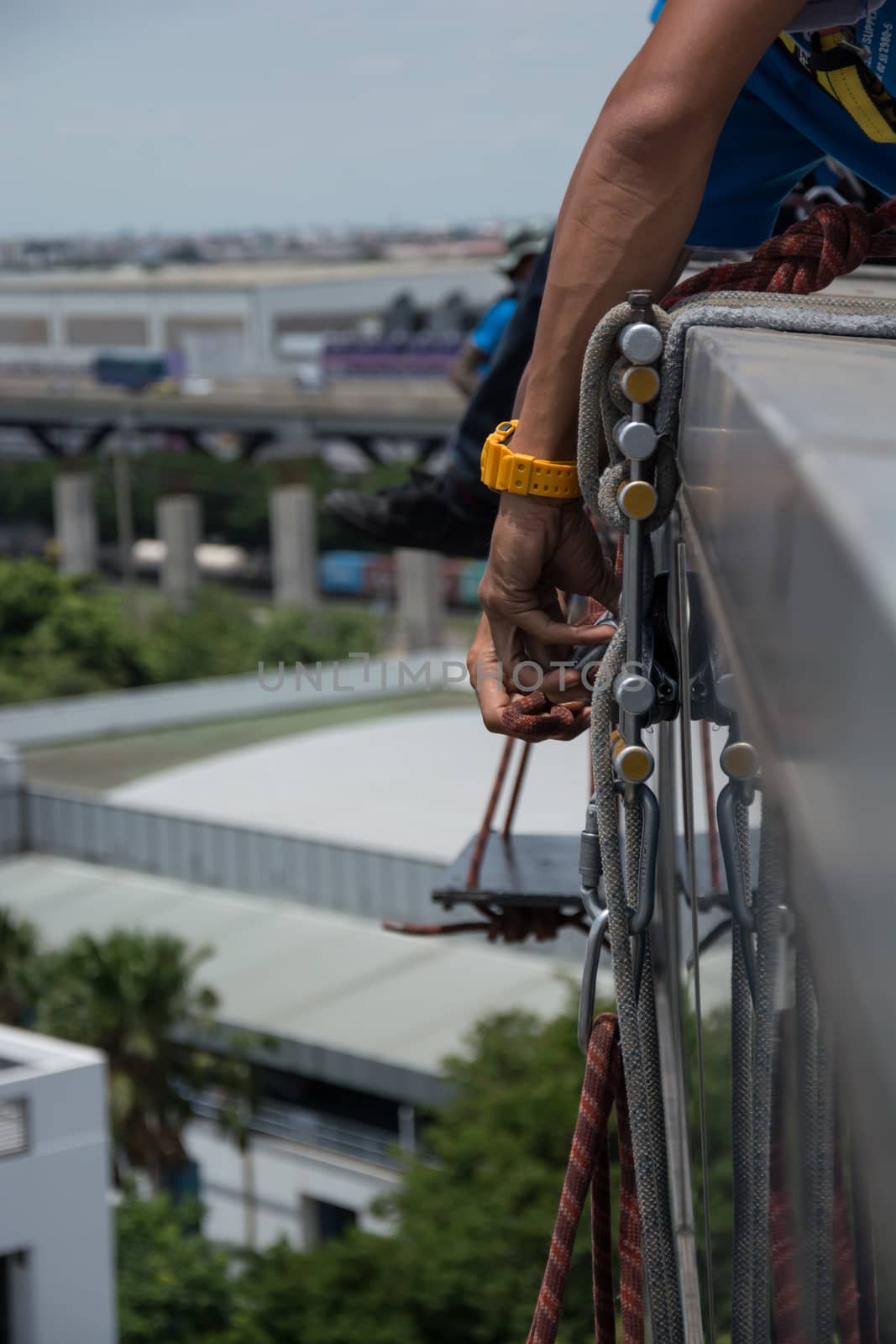 workers cleaning windows service on high rise building