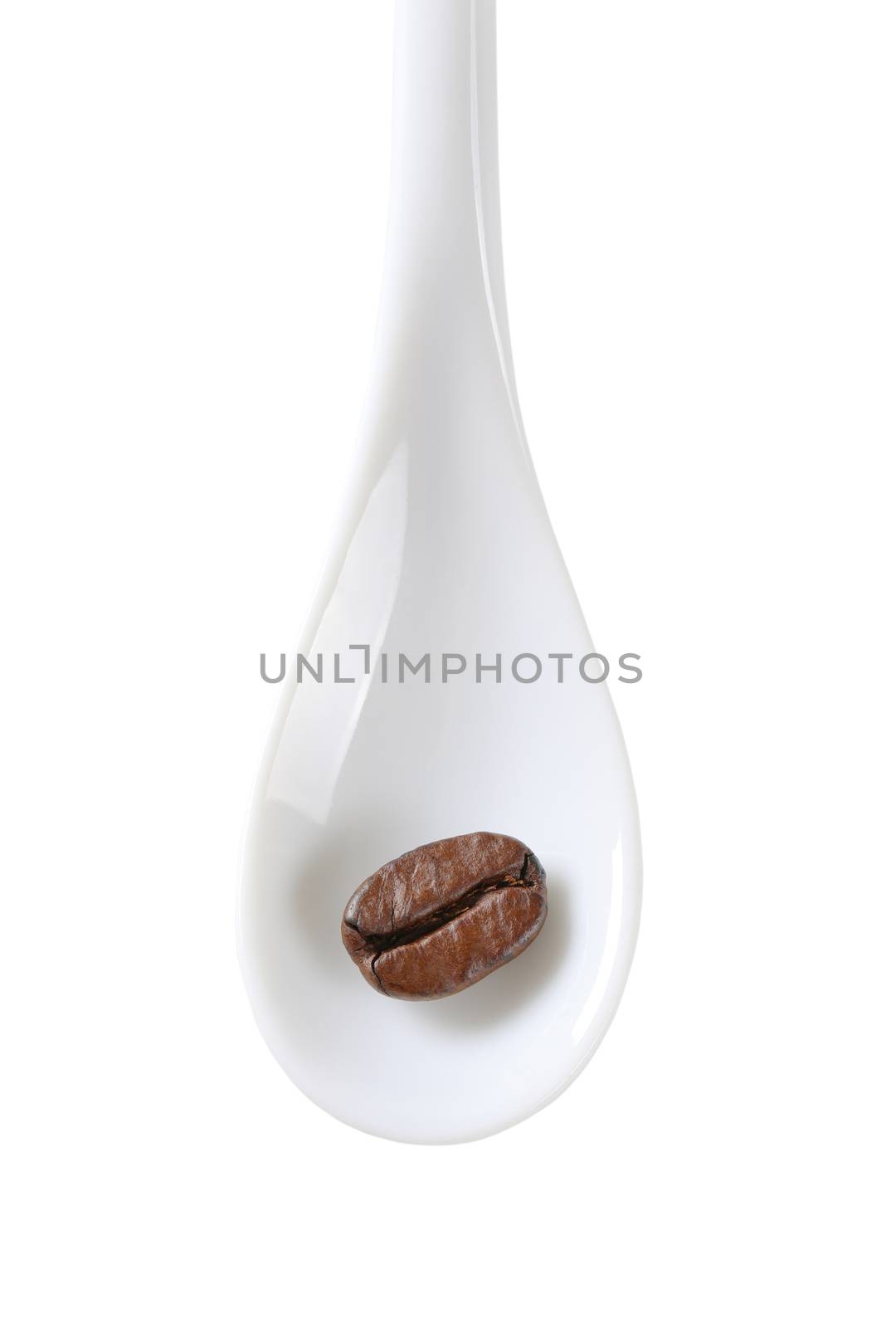 Single coffee bean on white spoon isolated on white by Digifoodstock