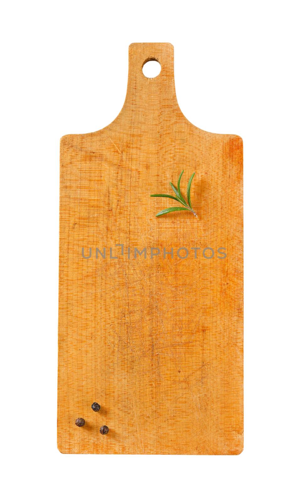 Wooden cutting board with rosemary and black peppercorns on it