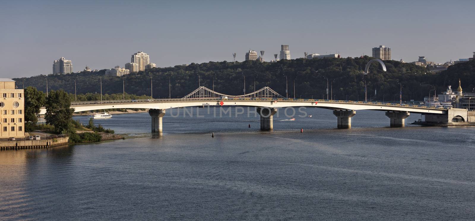 View of the Havana Bridge across the Dnipro River in Kiev in the rays of the evening sunset