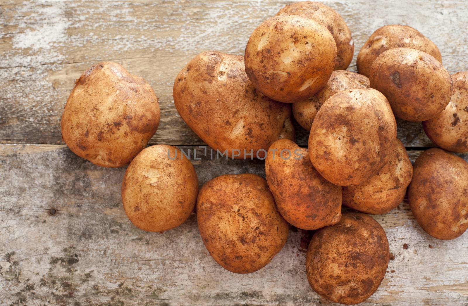 Pile of fresh whole farm potatoes by stockarch