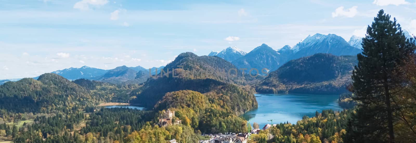 Beautiful nature of European Alps, landscape view of alpine mountains, lake and village on a sunny day, travel and destination by Anneleven