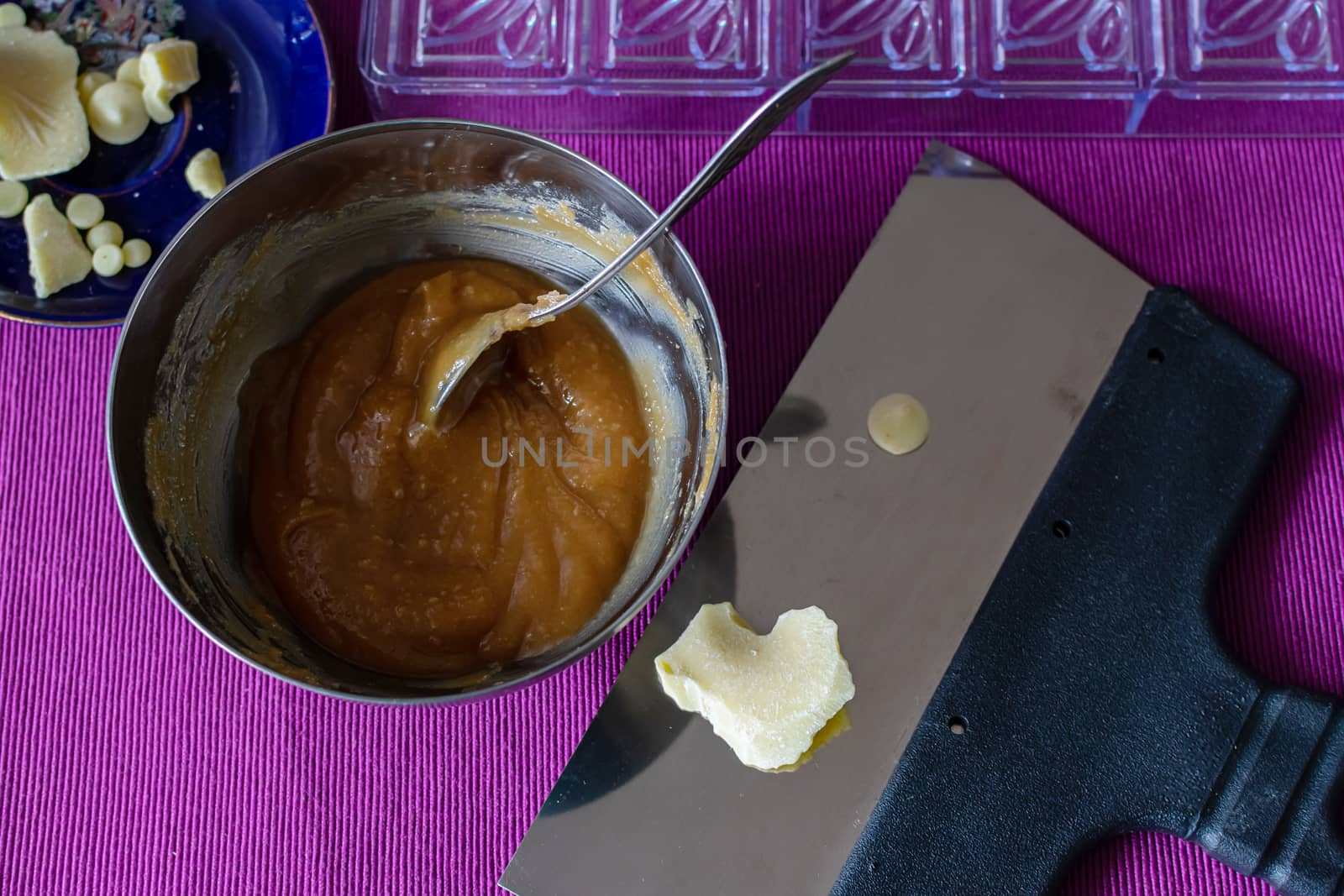 Close-up of a professional artisan pastry shop. A piece of white chocolate is prepared for home cooking useful and delicious sweets