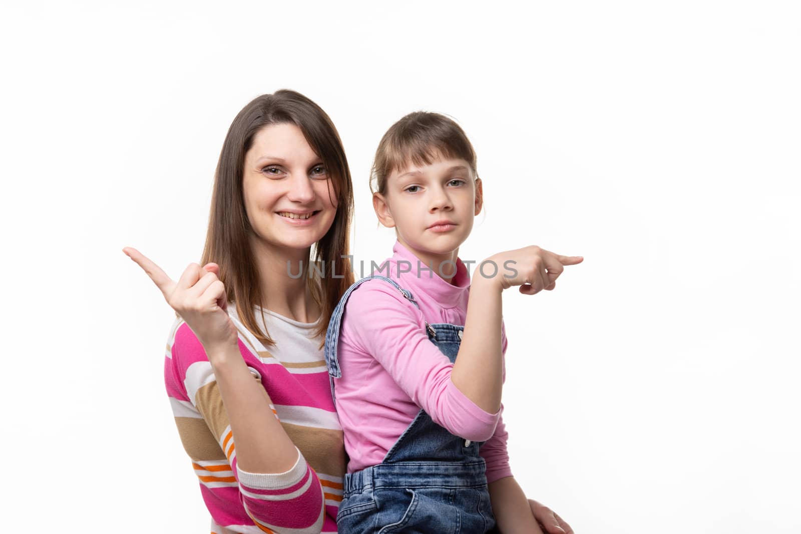 The girl joyfully points a finger in one direction, the girl is sad in the other
