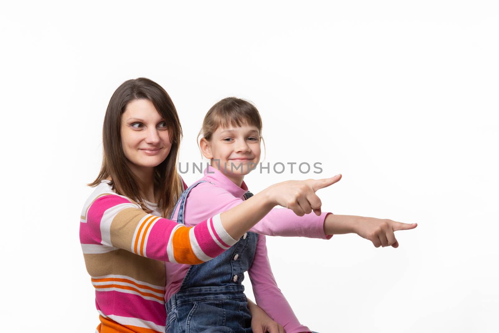 Mom and girl point a finger to an empty place