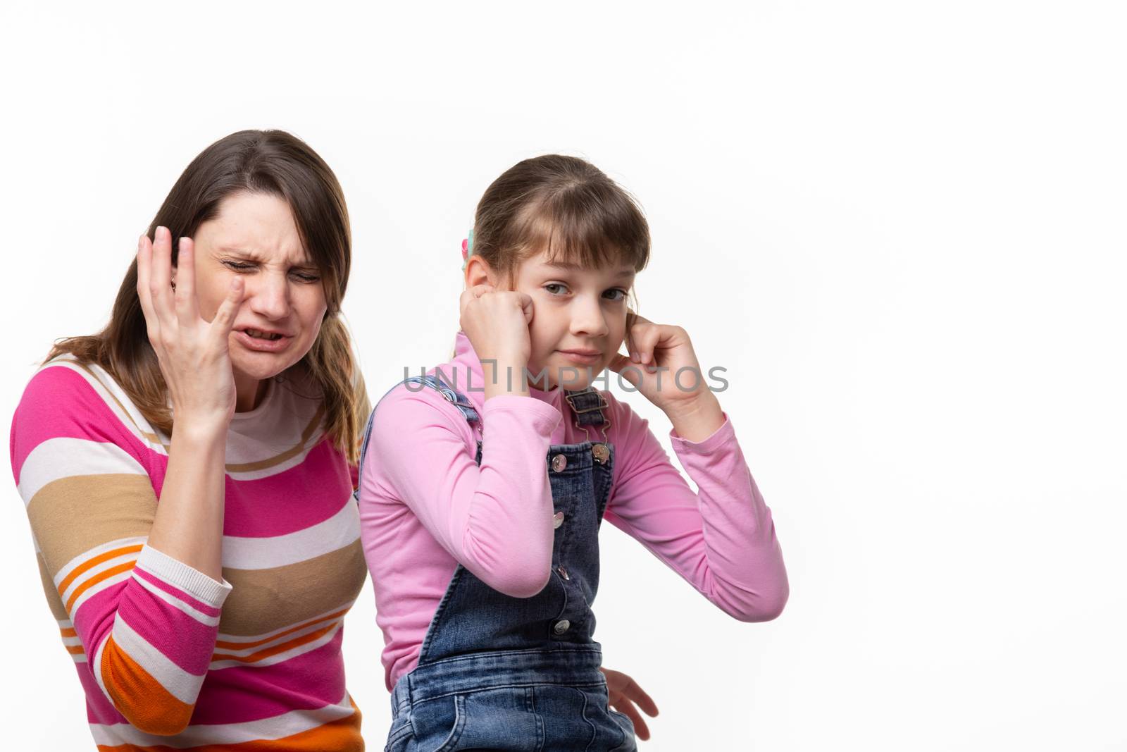 Girl sneezes, child plugged ears, isolated on white background