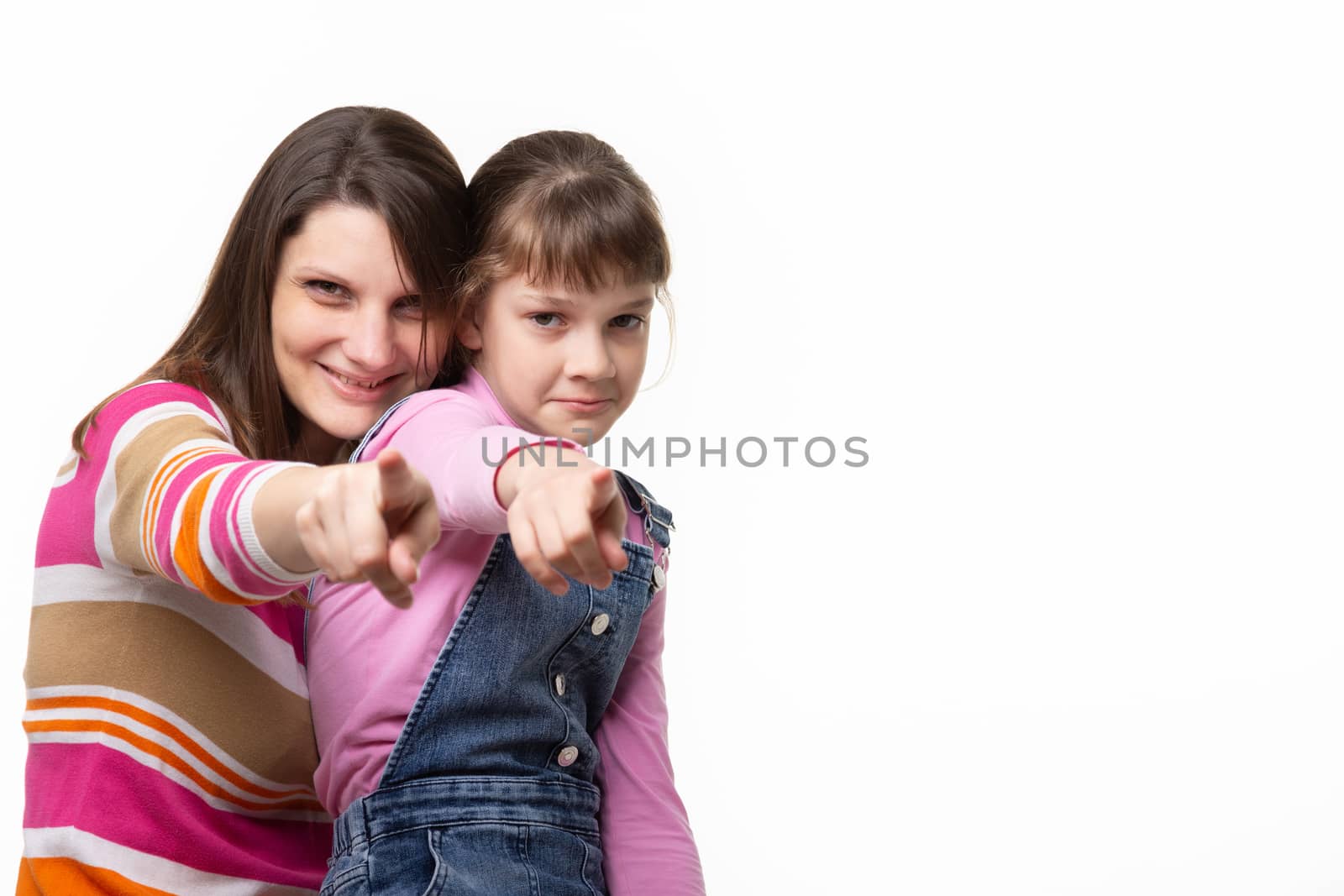 Mom and daughter point a finger at the frame, side empty space in the frame