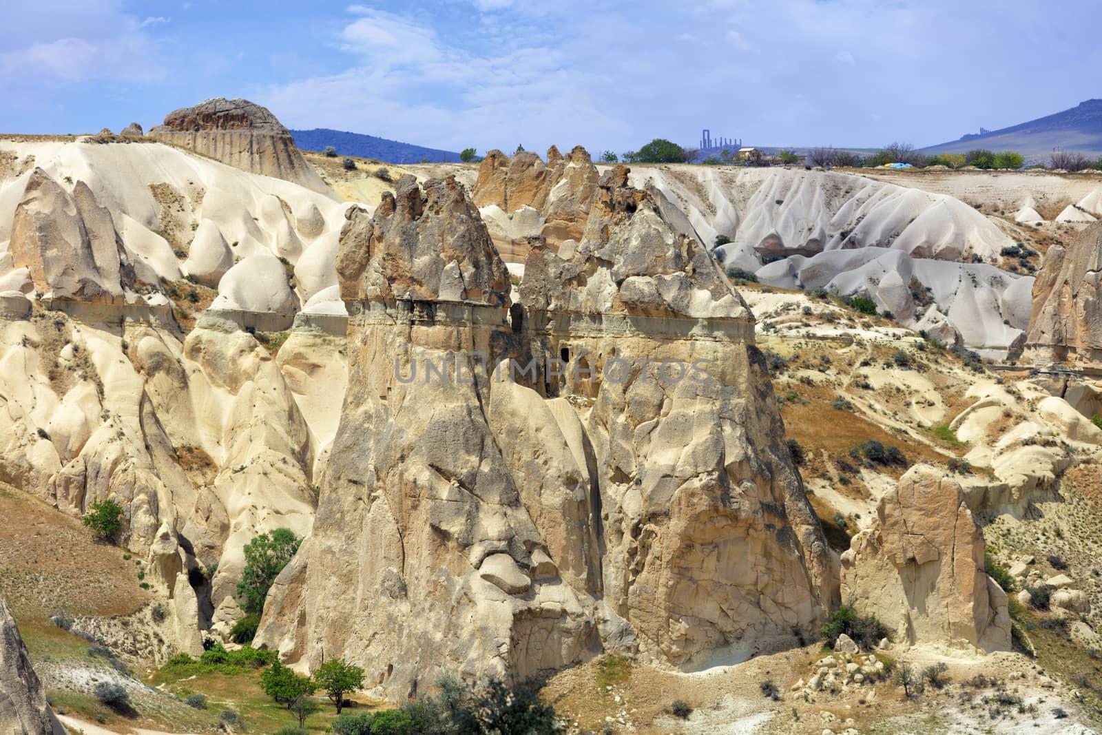 Red and white sandstone cliffs, ancient caves in a mountain landscape of valleys in Cappadocia, central Turkey