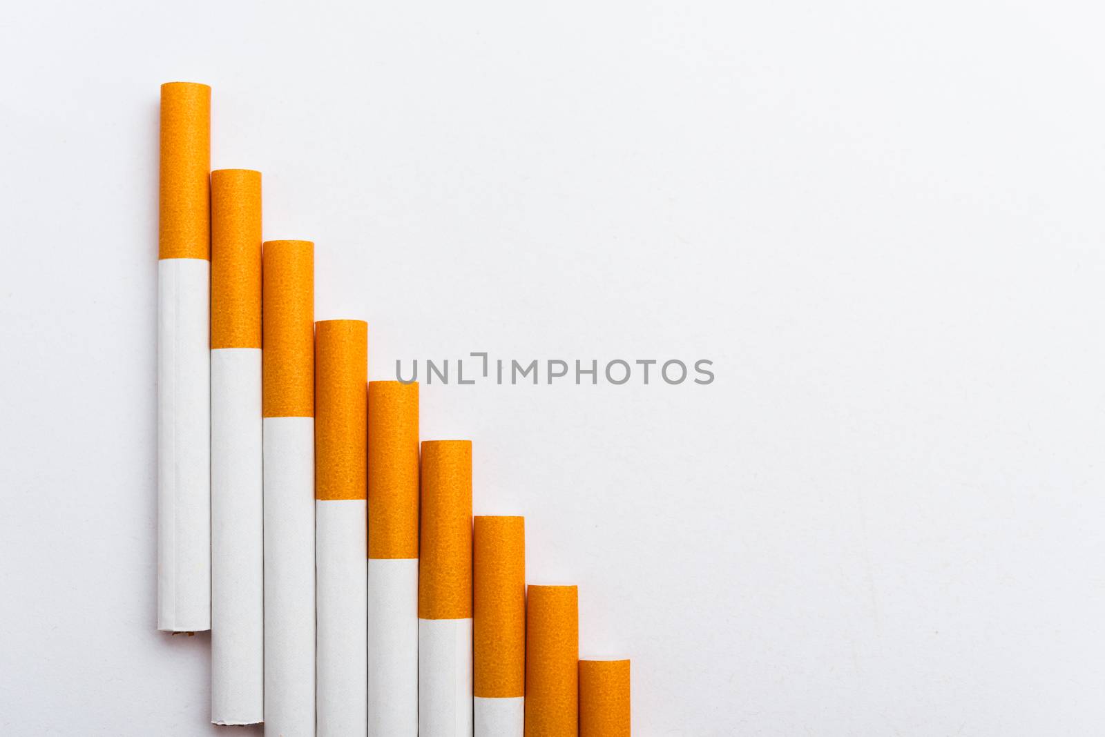 31 May of World No Tobacco Day, Close up step staircase pile cigarette or tobacco on white background with copy space, Smoking reduction campaign and Warning lung health concept