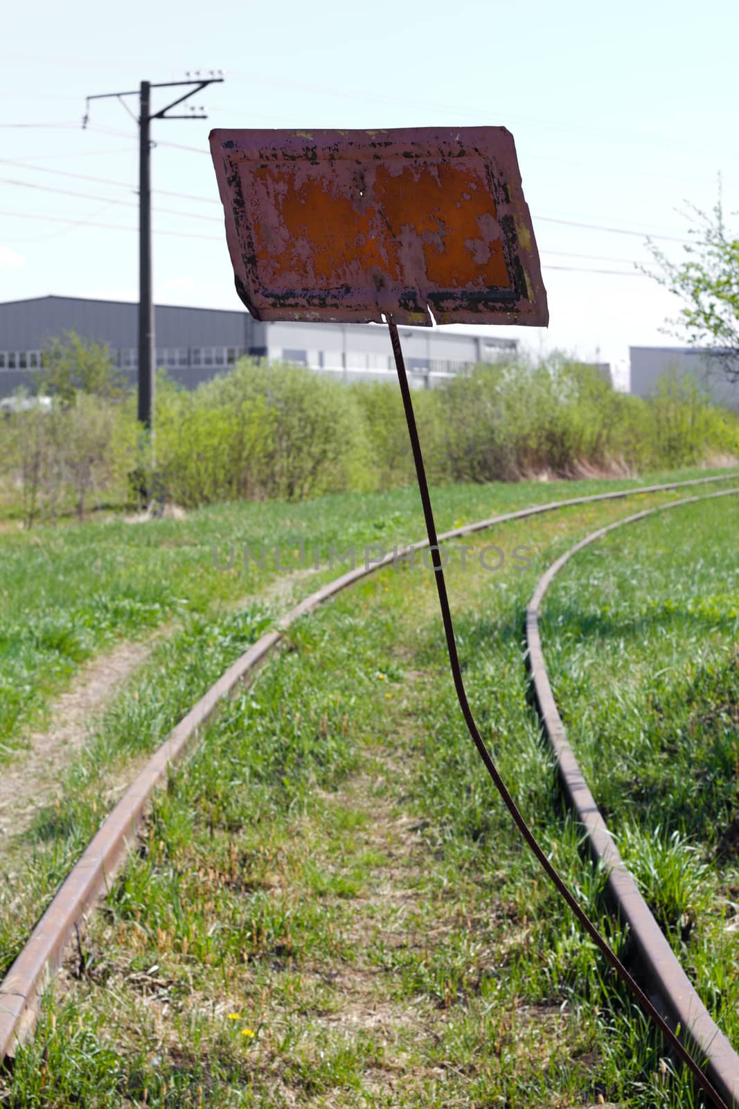 abandoned old rusty railway with road sign