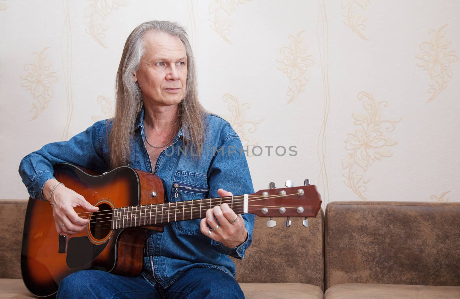 middle-aged man playing guitar by raddnatt