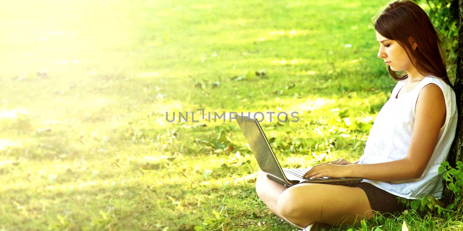 Young beautiful college student girl using laptop. by satariel