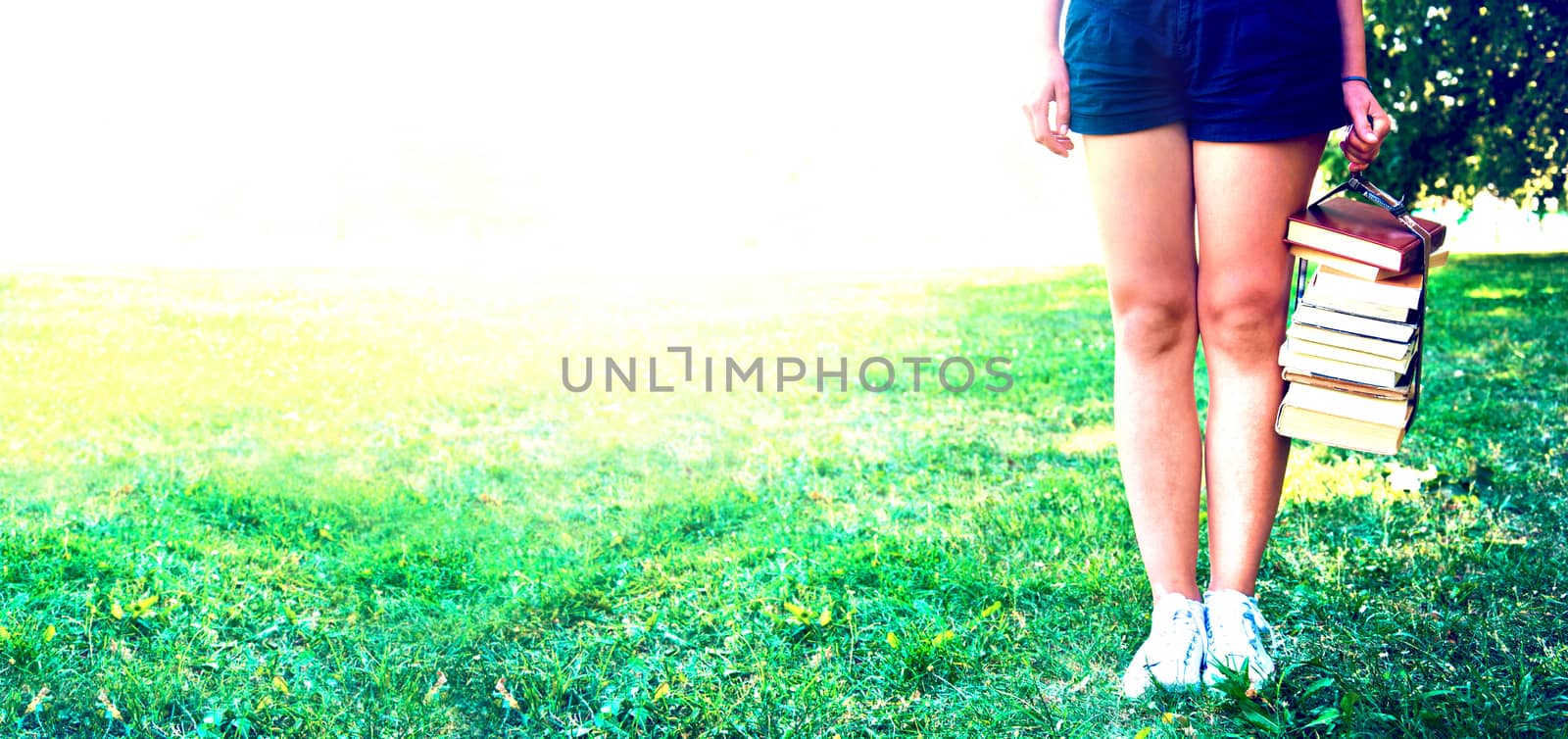 Girl holding a stack of books. Education. Back to school. Instagram vintage picture.