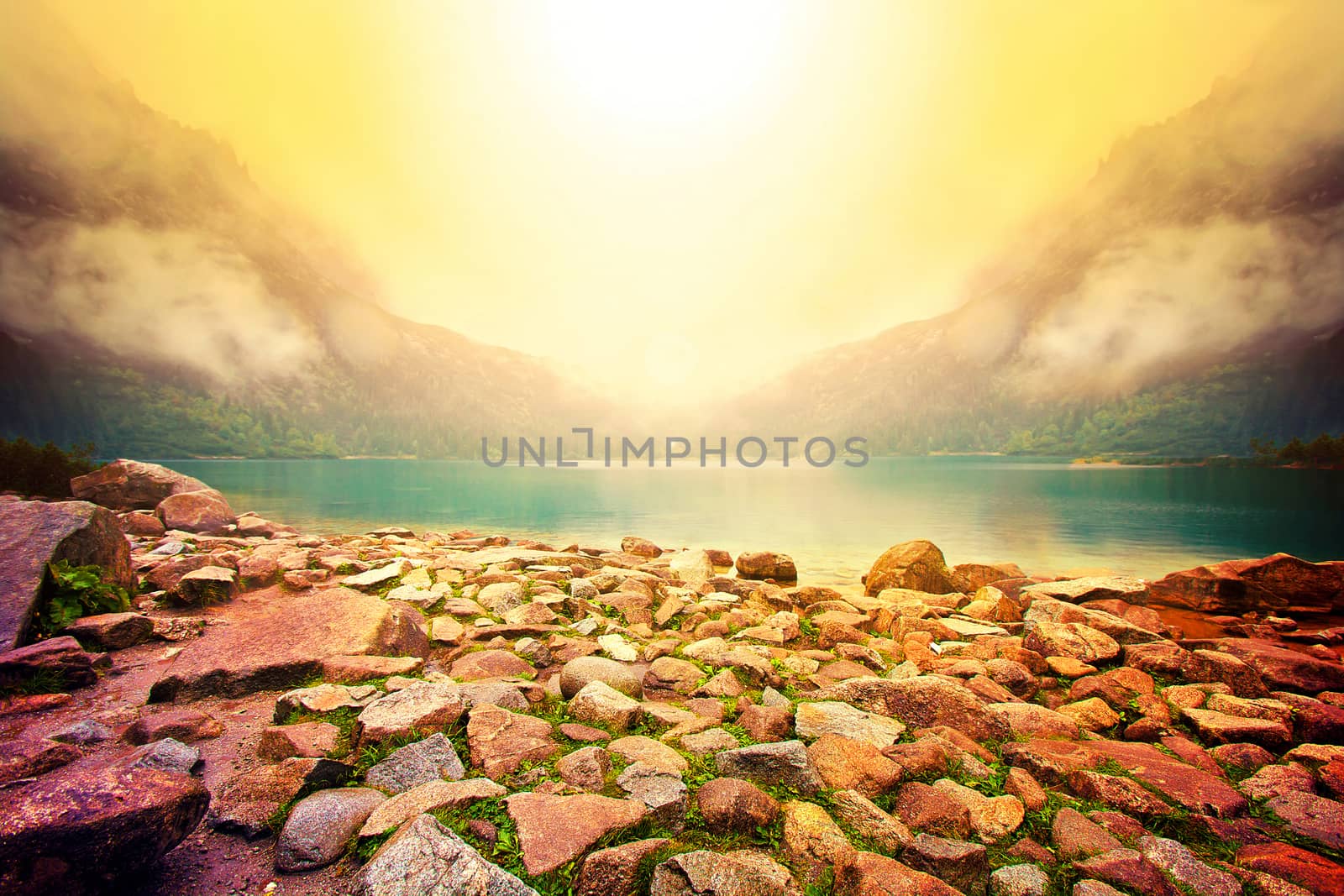 Fog over lake in mountains. Fantasy and colorfull nature landscape. Nature conceptual image. Morskie Oko in Tatry, Poland.