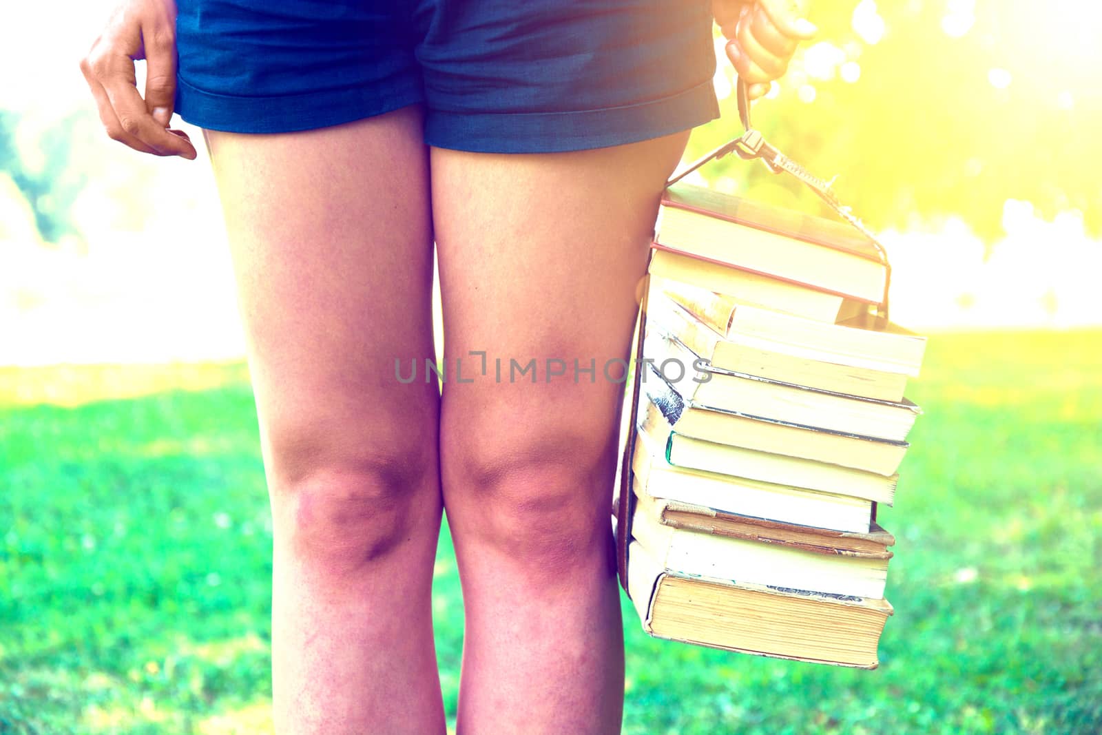 Girl holding a stack of books. Education. Back to school. Instagram vintage picture.