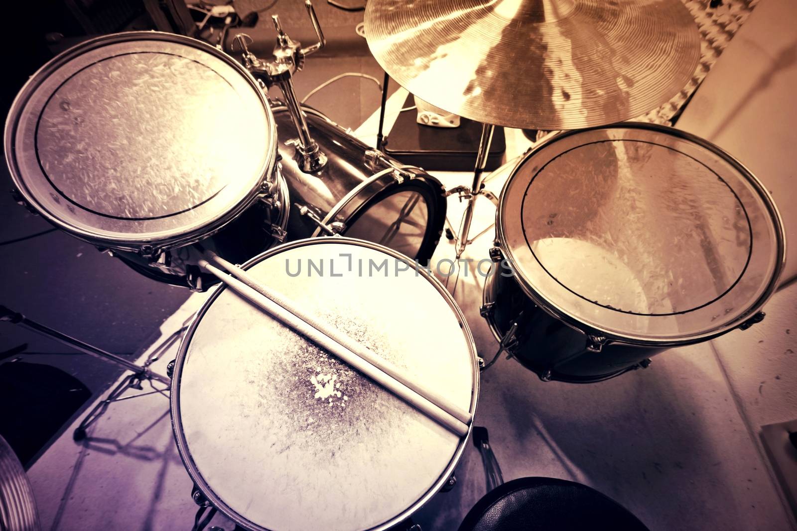 Drums conceptual image. Picture of drums and drumsticks lying on snare drum. Retro vintage instagram picture.