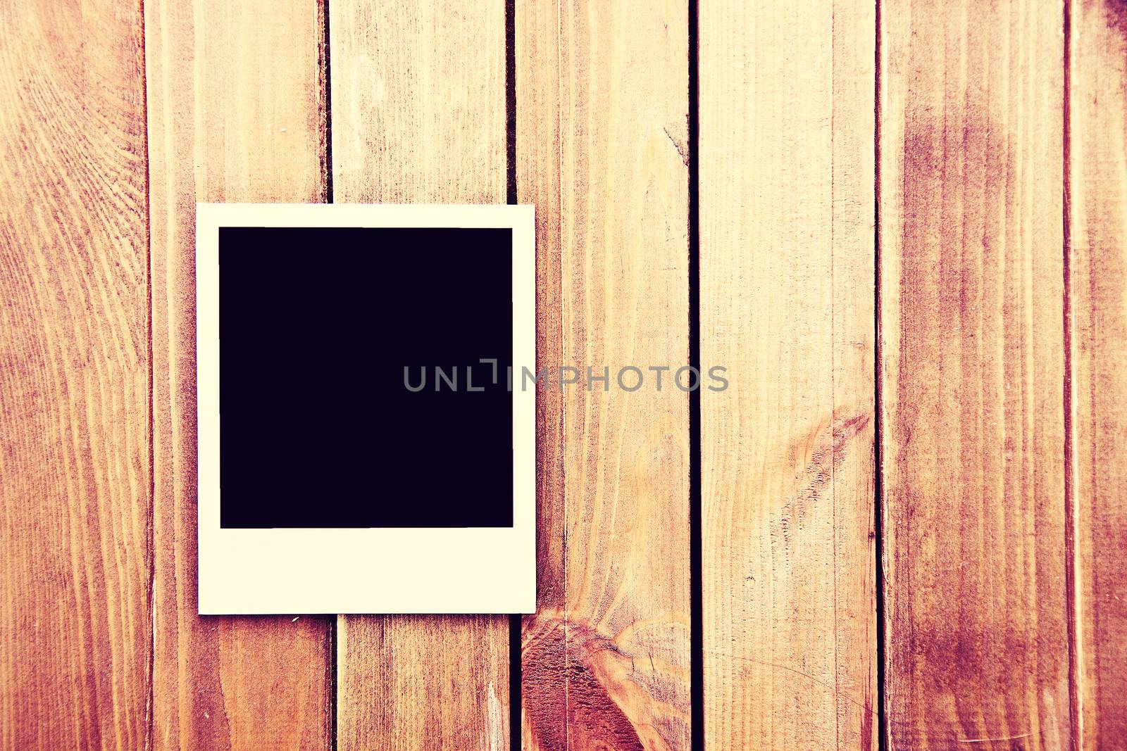 Instant blank polaroid photos frame on wooden background. Free copyspace. Vintage retro.