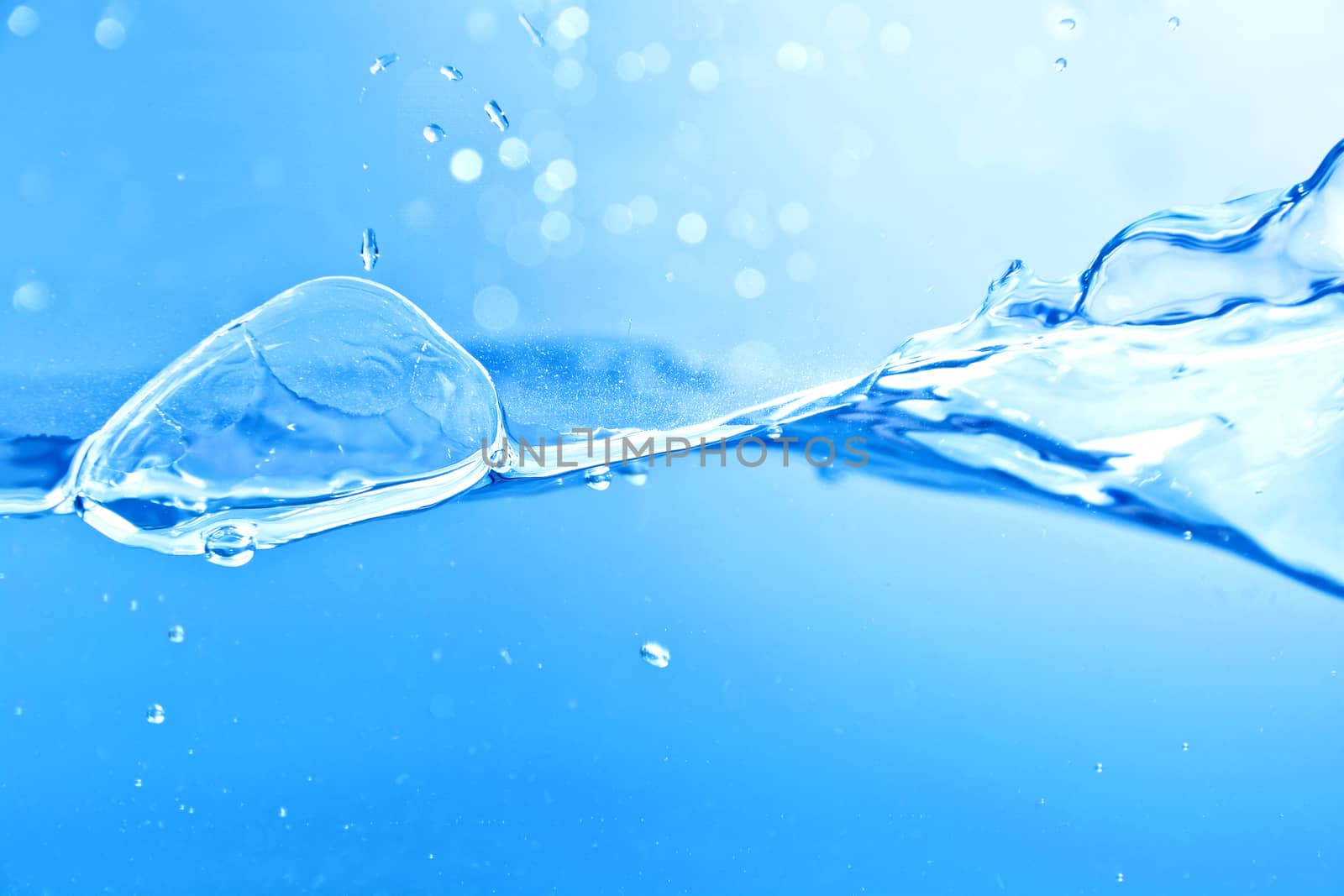 Water splash and air bubbles. Blue background.