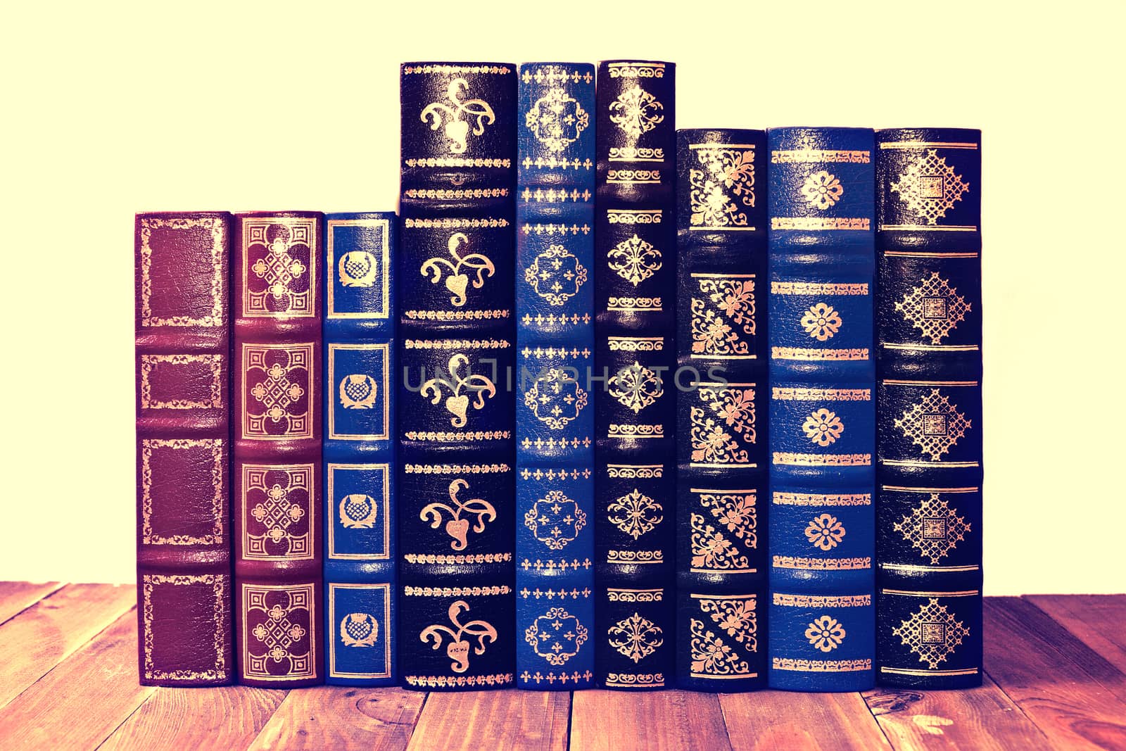 Old retro books on the wooden table and isolated background. Vintage.