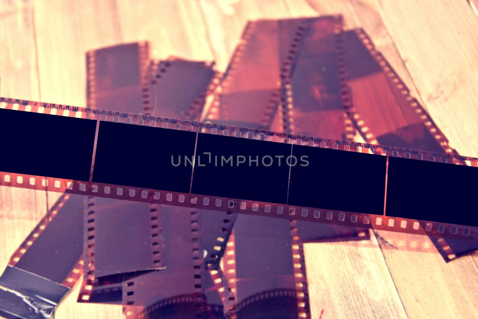 Photographic film on wooden background. by satariel