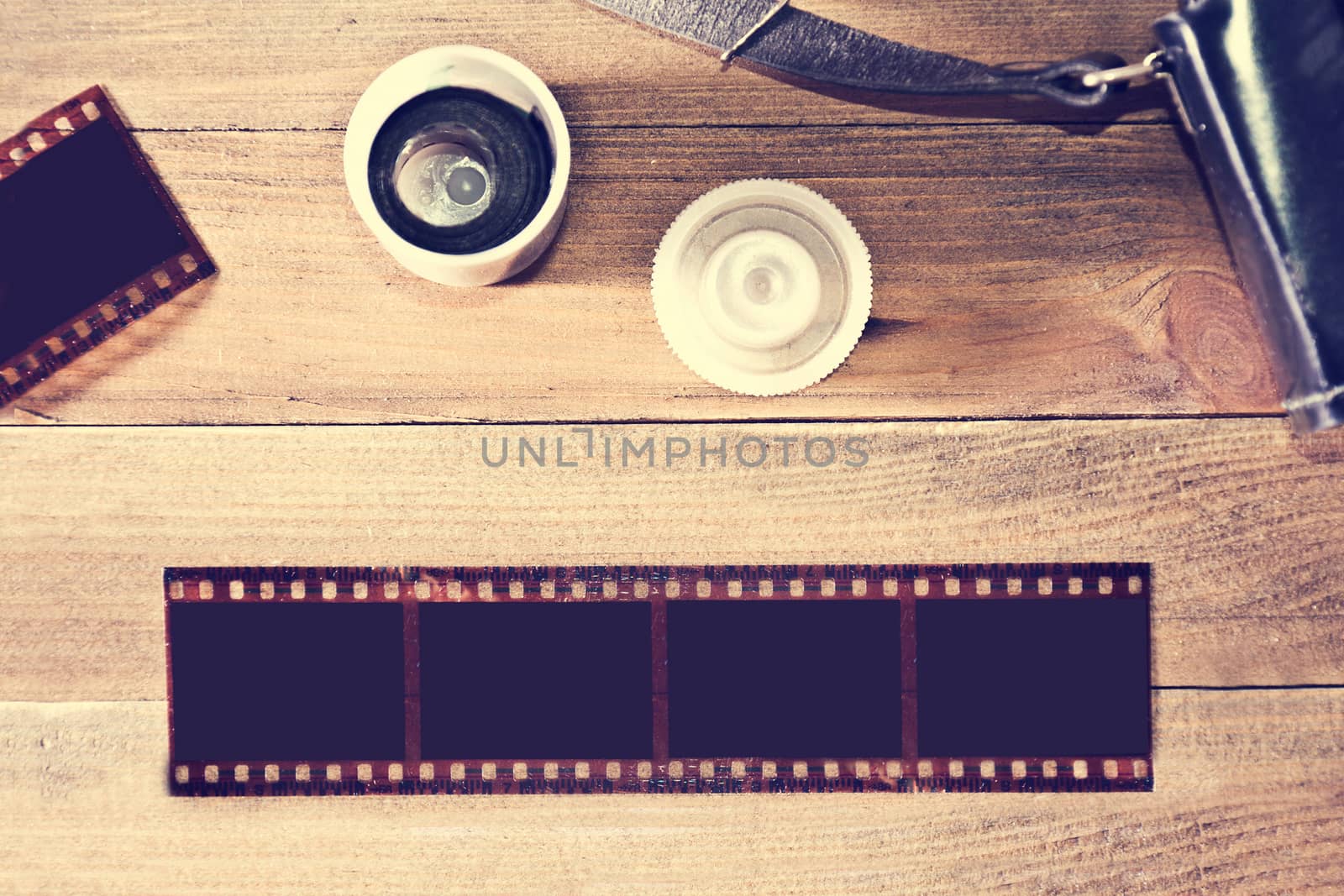 Photographic film on wooden background. by satariel