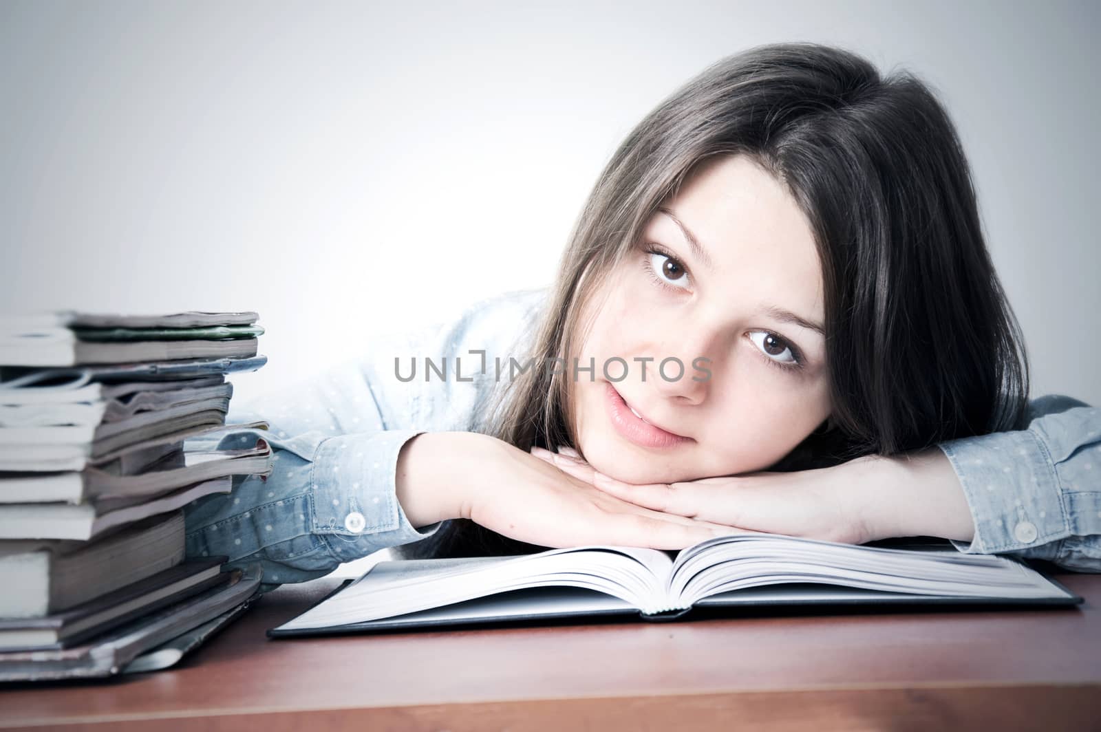 Cute smart young girl studying. Education conceptual image.