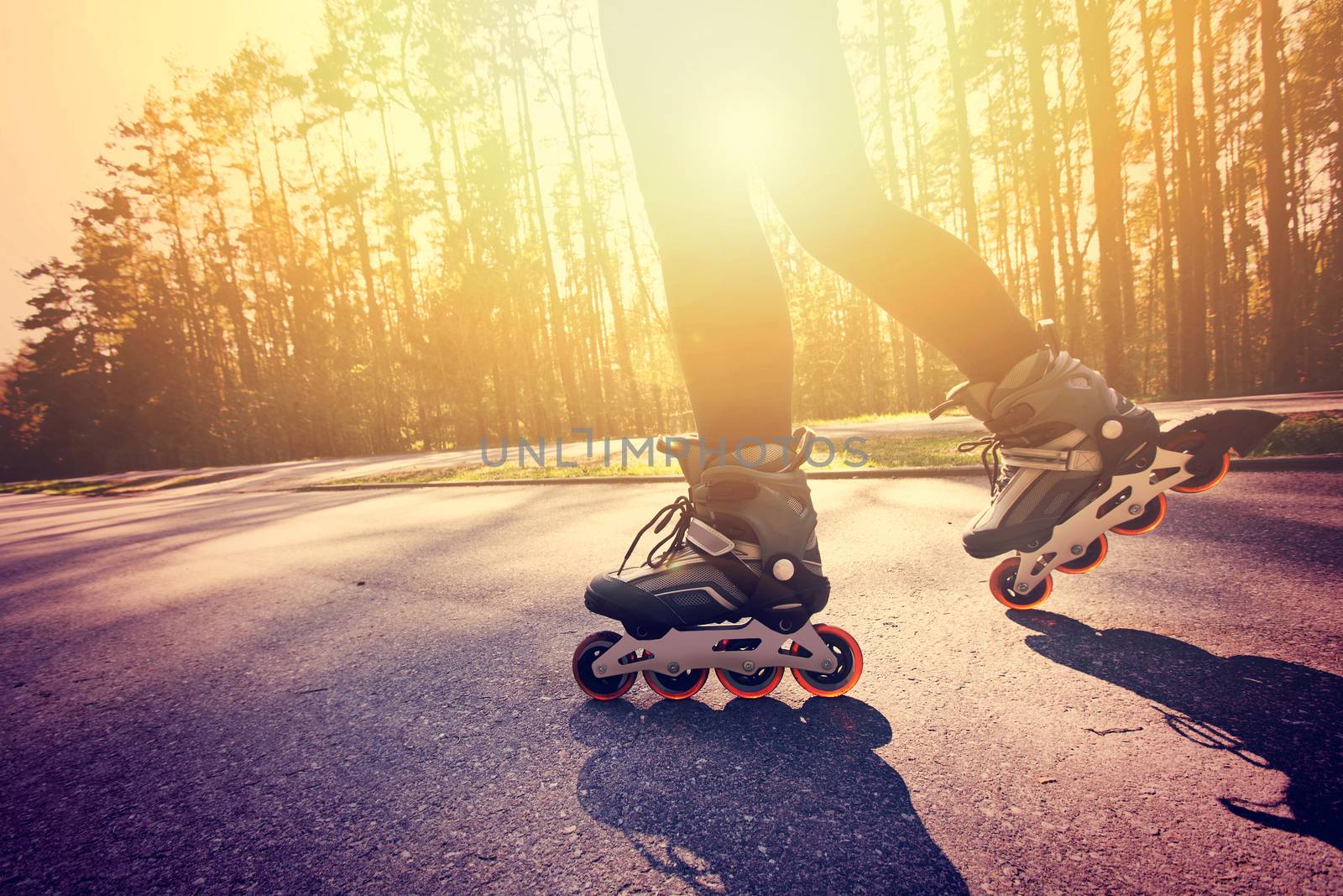 Teenage girl on roller skates at summer. Inline skates sport conceptual image.